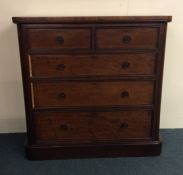 A massive mahogany flat front chest on moulded ped