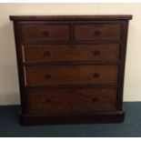 A massive mahogany flat front chest on moulded ped