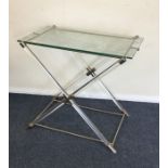 A rectangular retro glass top table on cross stret