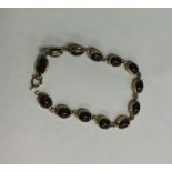 A heavy 9 carat cabochon garnet bracelet with ring