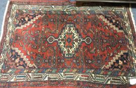 A small Oriental rug decorated in bright colours.