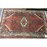 A small Oriental rug decorated in bright colours.