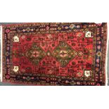 A small Oriental rug decorated in bright colours.