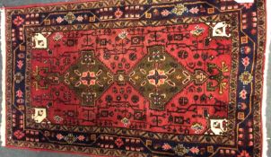 A small Oriental rug decorated in bright colours.