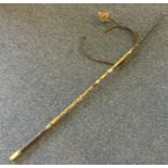 An old brass mounted riding crop. Est. £30 - £50.