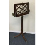 A Victorian mahogany music stand with brass sconce
