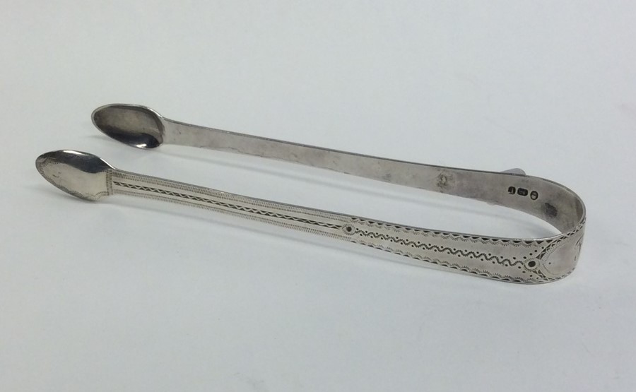 A pair fo Georgian bright cut silver sugar tongs w