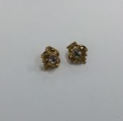 A pair of Victorian scroll decorated earrings engr