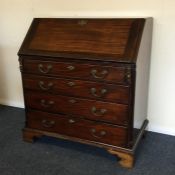 A Georgian oak bureau with four drawers and ball f