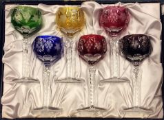 A boxed set of six coloured stemmed glasses. Est.