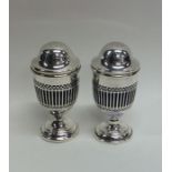 A pair of Edwardian silver pierced peppers with do