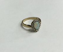 An opal and diamond cluster ring set in gold. Appr