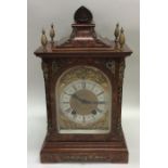 A burr walnut cased mantle clock with brass scroll