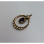 A Victorian amethyst and pearl pendant with loop t