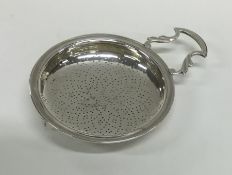 NEWCASTLE: A Georgian silver lemon strainer of typ