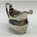 A Georgian silver helmet shaped cream jug with ree