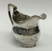 A Georgian silver helmet shaped cream jug with ree