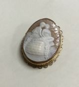 A 9 carat oval cameo depicting a romantic scene. A