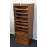 An oak tambour front stationery cabinet. Est. £80