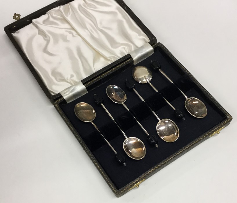 A boxed set of six silver bean top coffee spoons.
