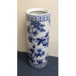 A tall blue and white pottery stick stand decorate