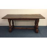 An oak occasional table on stretcher base. Est. £3