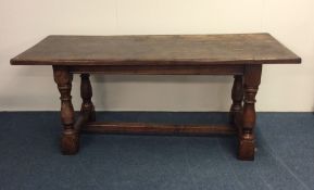 An oak occasional table on stretcher base. Est. £3