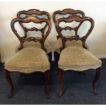 A set of four Victorian rosewood hoop backed chair