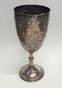 A Georgian style embossed silver trophy cup decora