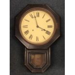 An old mahogany school clock with hinged front and