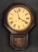 An old mahogany school clock with hinged front and