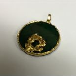An 18 carat gold and malachite circular pendant de