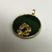 An 18 carat gold and malachite circular pendant de