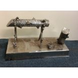 A large chrome moneybox in the form of a log on st
