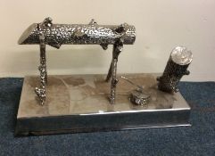 A large chrome moneybox in the form of a log on st