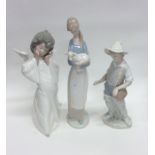 A Lladro figure of a shepherdess together with two