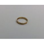 An 18 carat wedding band with Greek key pattern. A