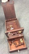 An Antique mahogany travelling sewing set with ree