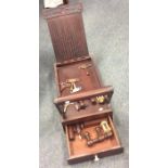 An Antique mahogany travelling sewing set with ree