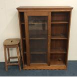 A stripped pine glazed cabinet together with a pin