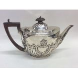 A good quality silver half fluted teapot with flor