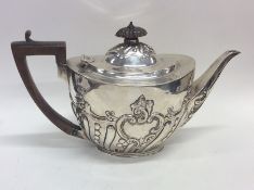 A good quality silver half fluted teapot with flor
