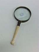 An unusual carved ivory mounted magnifier in the f