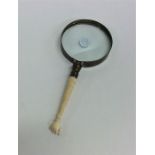 An unusual carved ivory mounted magnifier in the f