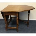 A small oak drop leaf table. Est. £20 - £30.