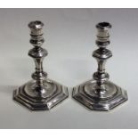 A pair of Georgian style cast silver taper candles