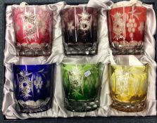 A boxed set of six coloured glass tumblers. Est. £