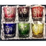 A boxed set of six coloured glass tumblers. Est. £