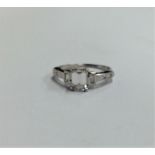 An attractive emerald cut diamond single stone rin