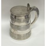 A Georgian silver tankard with reeded tapering sid
